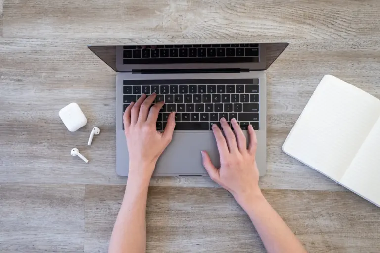 Hands typing a refund request on a laptop